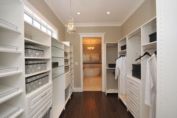 Custom white wood bedroom closet organizer system by YYC Closets & Glass