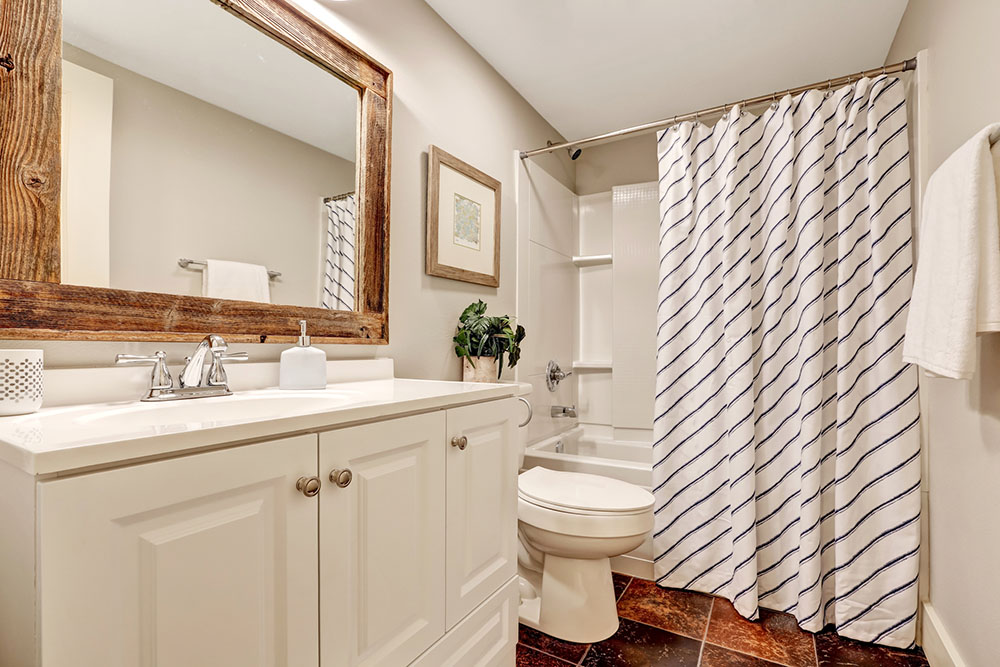 White Bathroom with custom wooden framed mirror by YYC Closets & Glass.