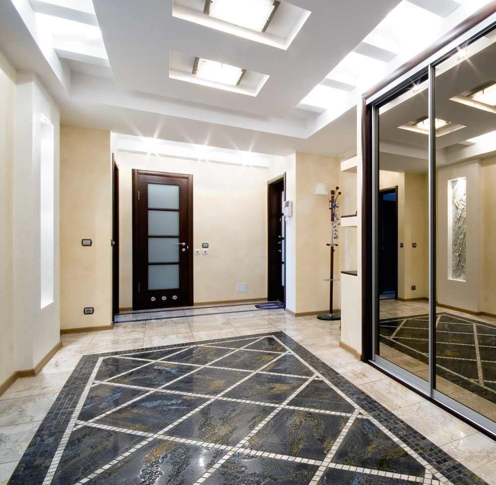 Custom sliding mirror closet doors by YYC Closets & Glass in luxury hall in a new apartment